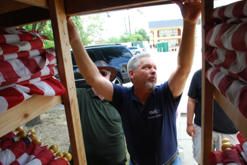 Ken Goodman surveys the inventory in a storage trailer that holds 543 large American flags....