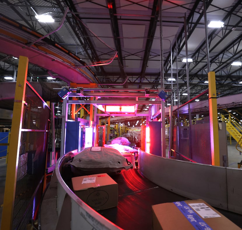 A machine scans packages at the Amazon North Texas Air Hub in Haslet, TX, on Jul 16, 2024. ...