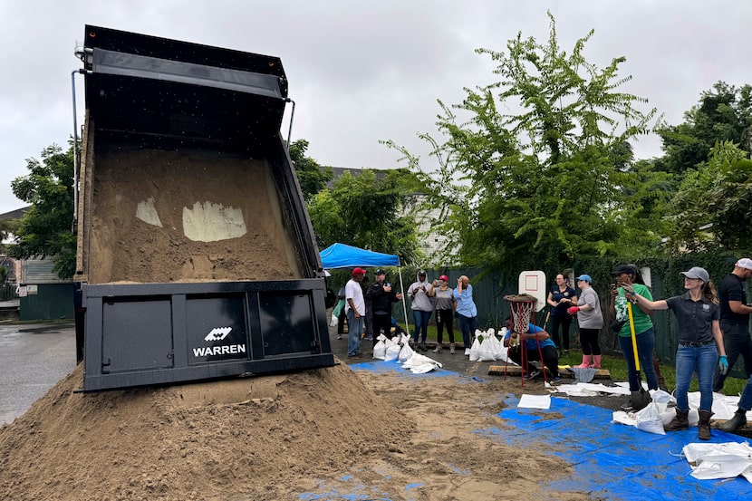 Residents fill up sand bags to protect their homes in anticipation of Tropical Storm...