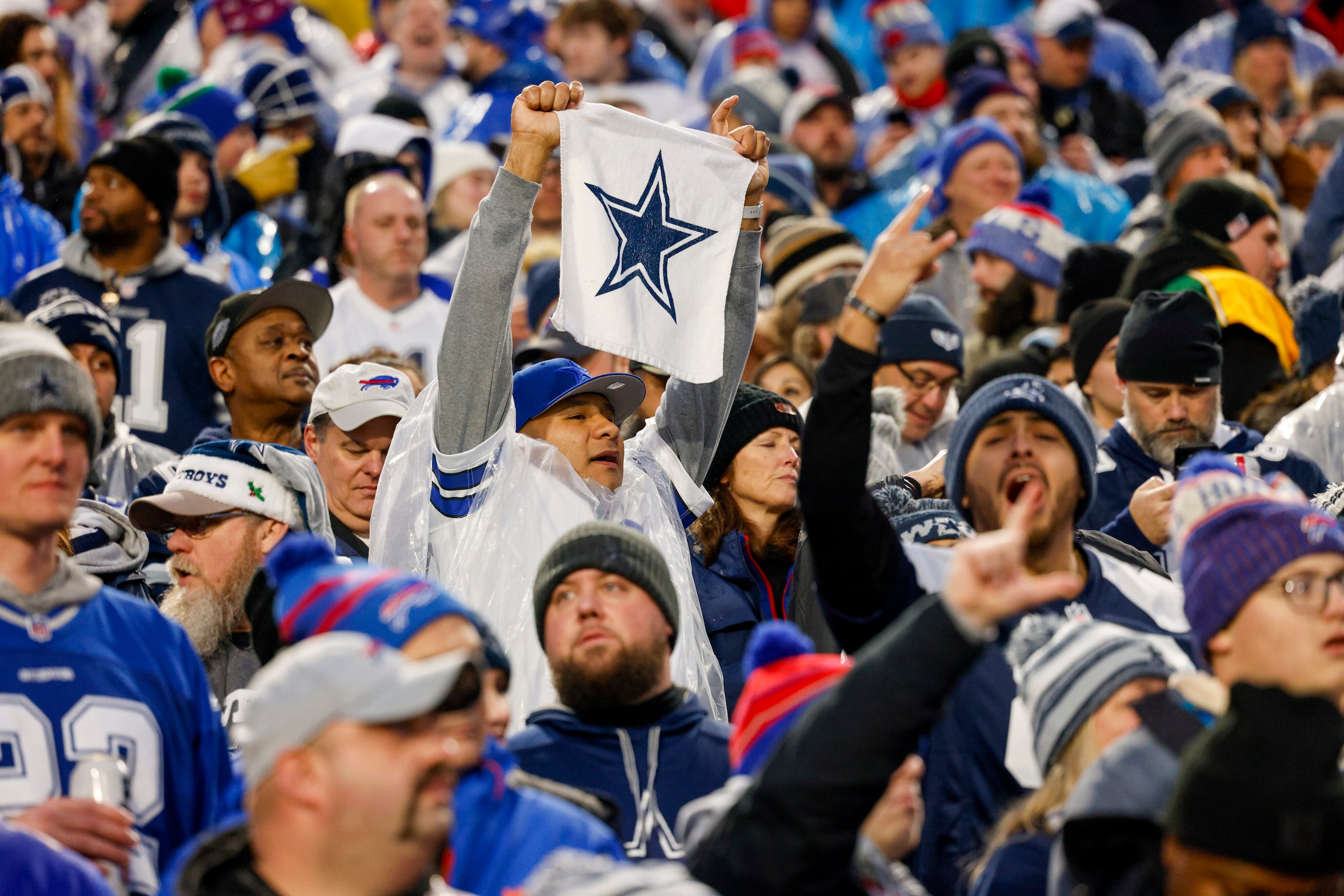 A Dallas Cowboys fan raises a towel before the first half of an NFL game against the Buffalo...