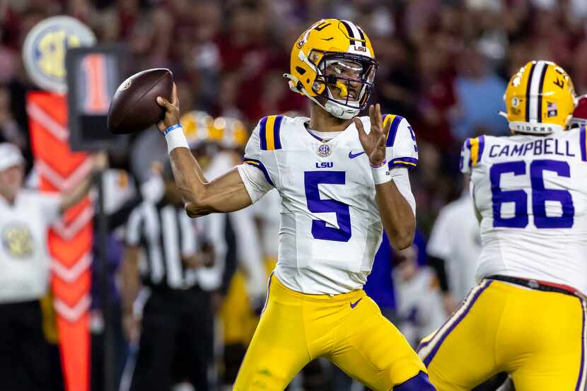 LSU quarterback Jayden Daniels (5) throws a passduring the first half of an NCAA college...