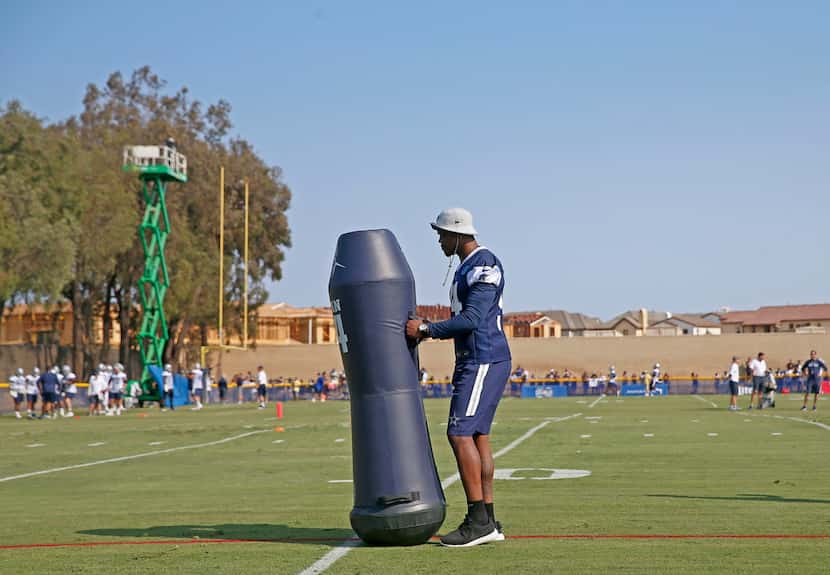 Dallas Cowboys defensive end Randy Gregory moves a blocking dummy during afternoon practice...