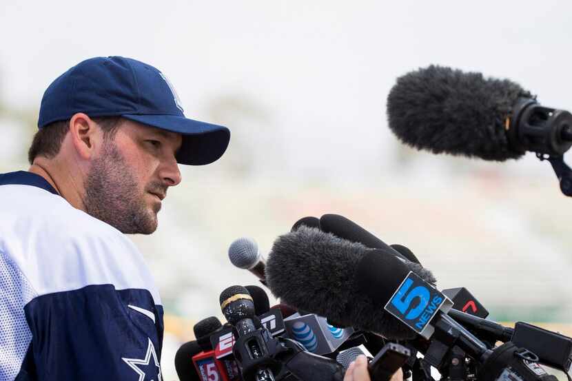 Dallas Cowboys quarterback Tony Romo faces a wall of microphones following the morning...