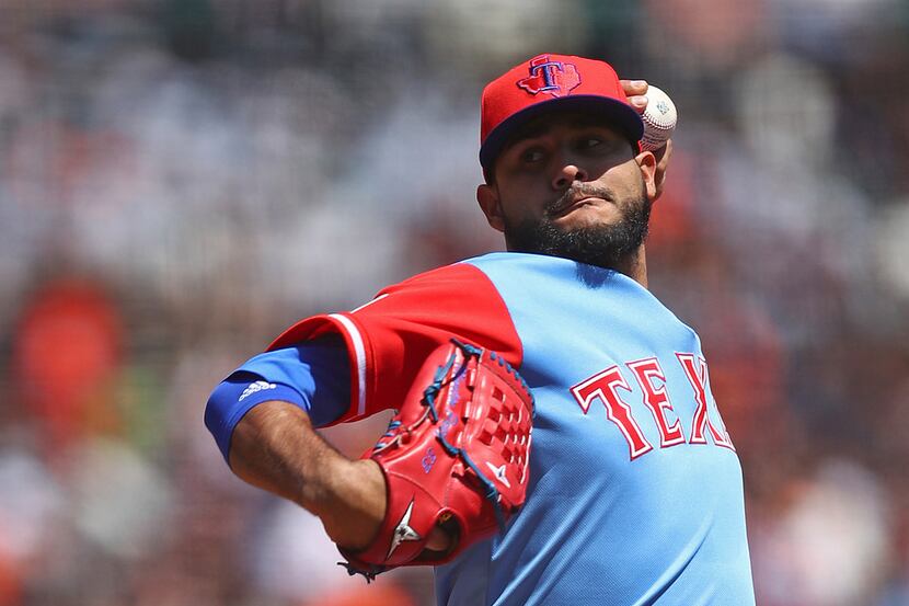Texas Rangers pitcher Martin Perez works against the San Francisco Giants in the first...