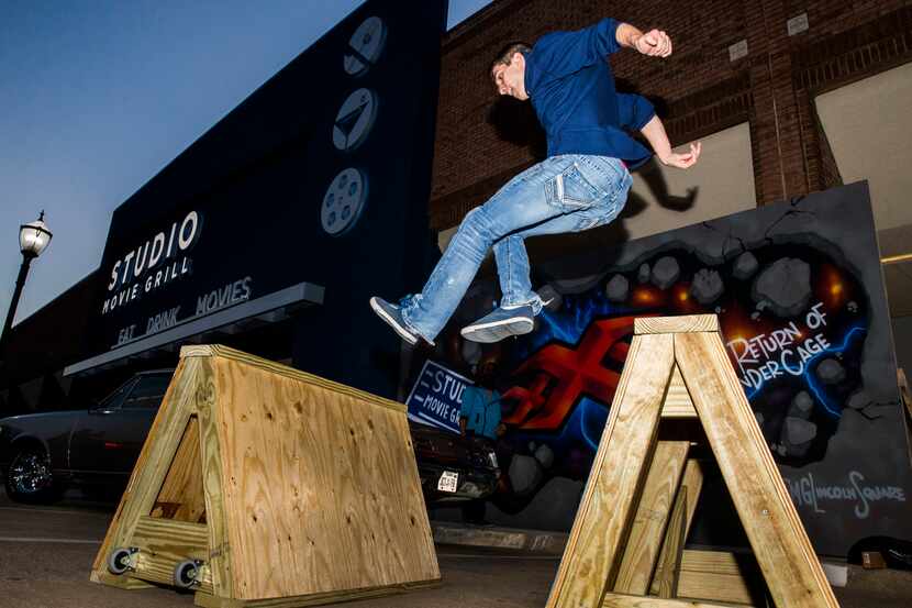 Parkour performer Cody McConnell jumps over hurdles as Studio Movie Grill opens it's 24th...