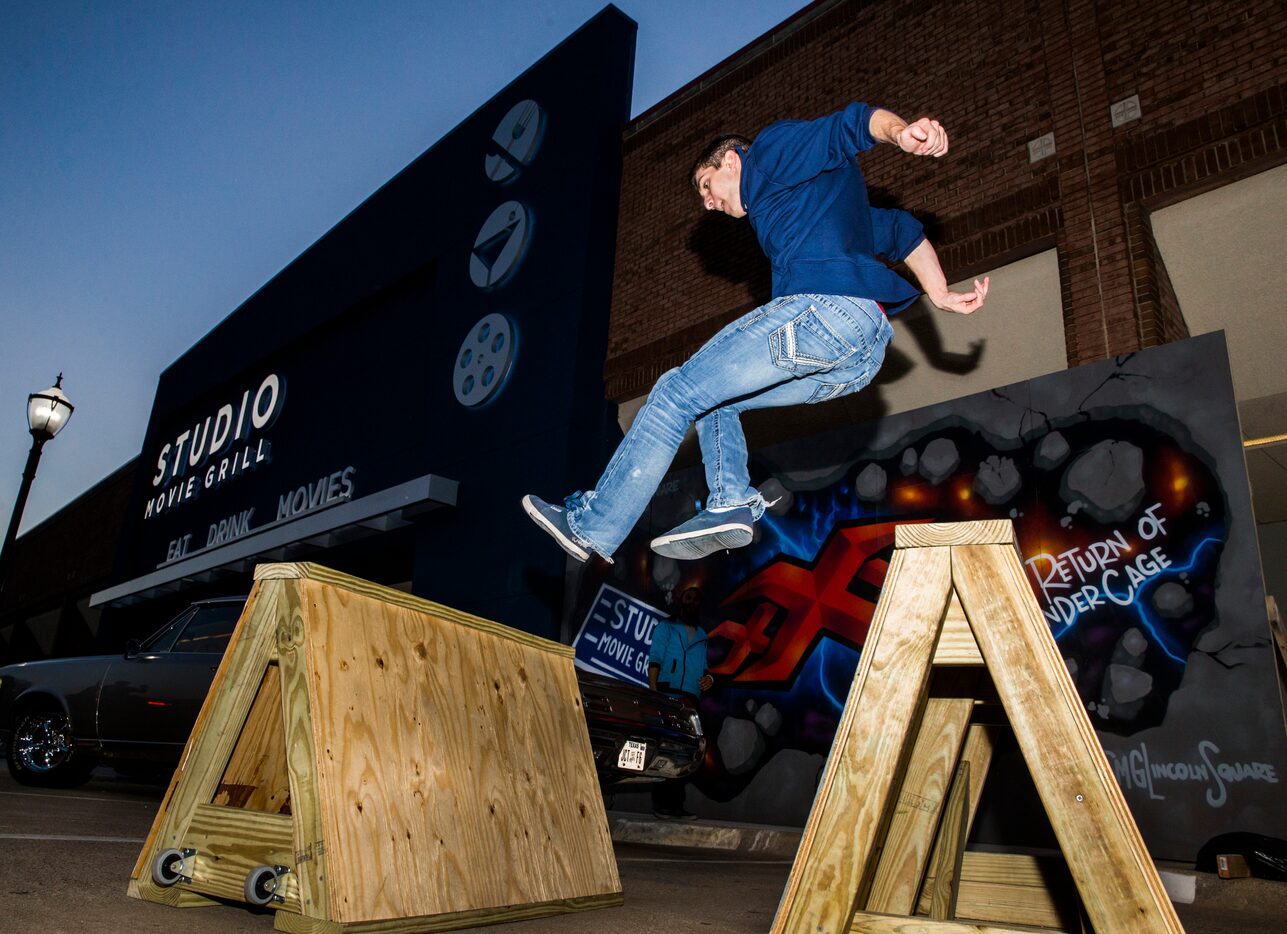 Parkour performer Cody McConnell jumps over hurdles as Studio Movie Grill opens it's 24th...