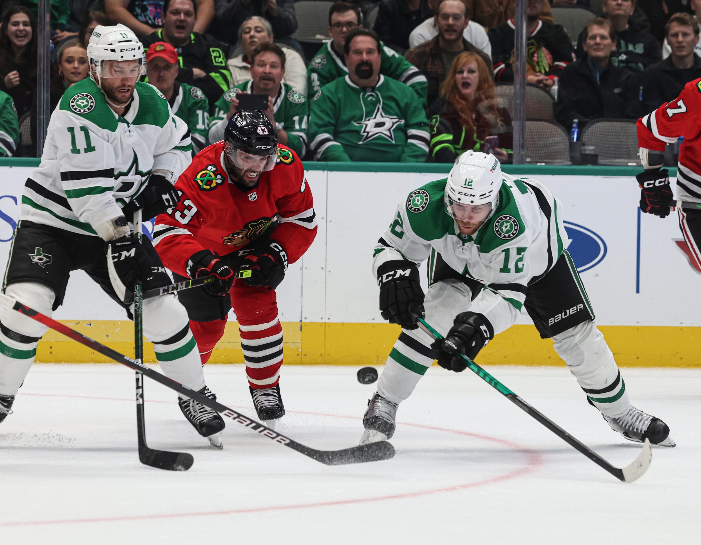 Dallas Stars center Luke Glendening (11), Chicago Blackhawks center Colin Blackwell (43) and...