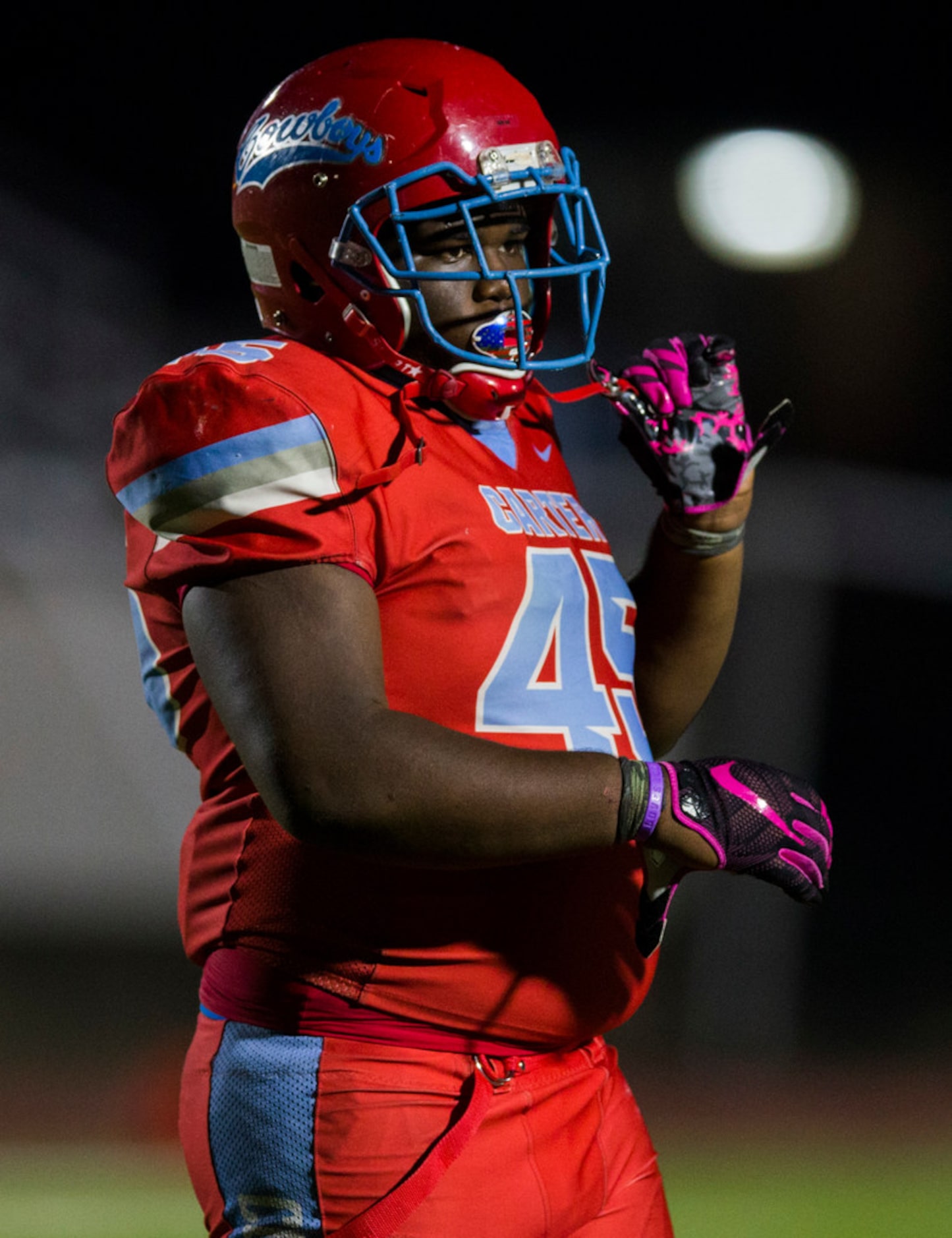 Carter defensive lineman Branard Wright (45) loosens his helmet during the fourth quarter of...