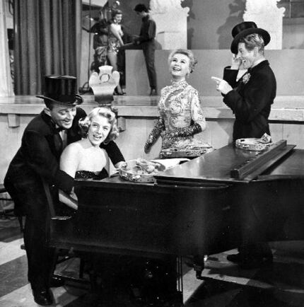 Rosemary Clooney, at piano, with Bing Crosby (left) and Vera-Ellen and Danny Kaye in a scene...