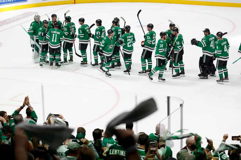 Dallas Stars players congratulate one another following a 4-2 win over the Calgary Flames in...