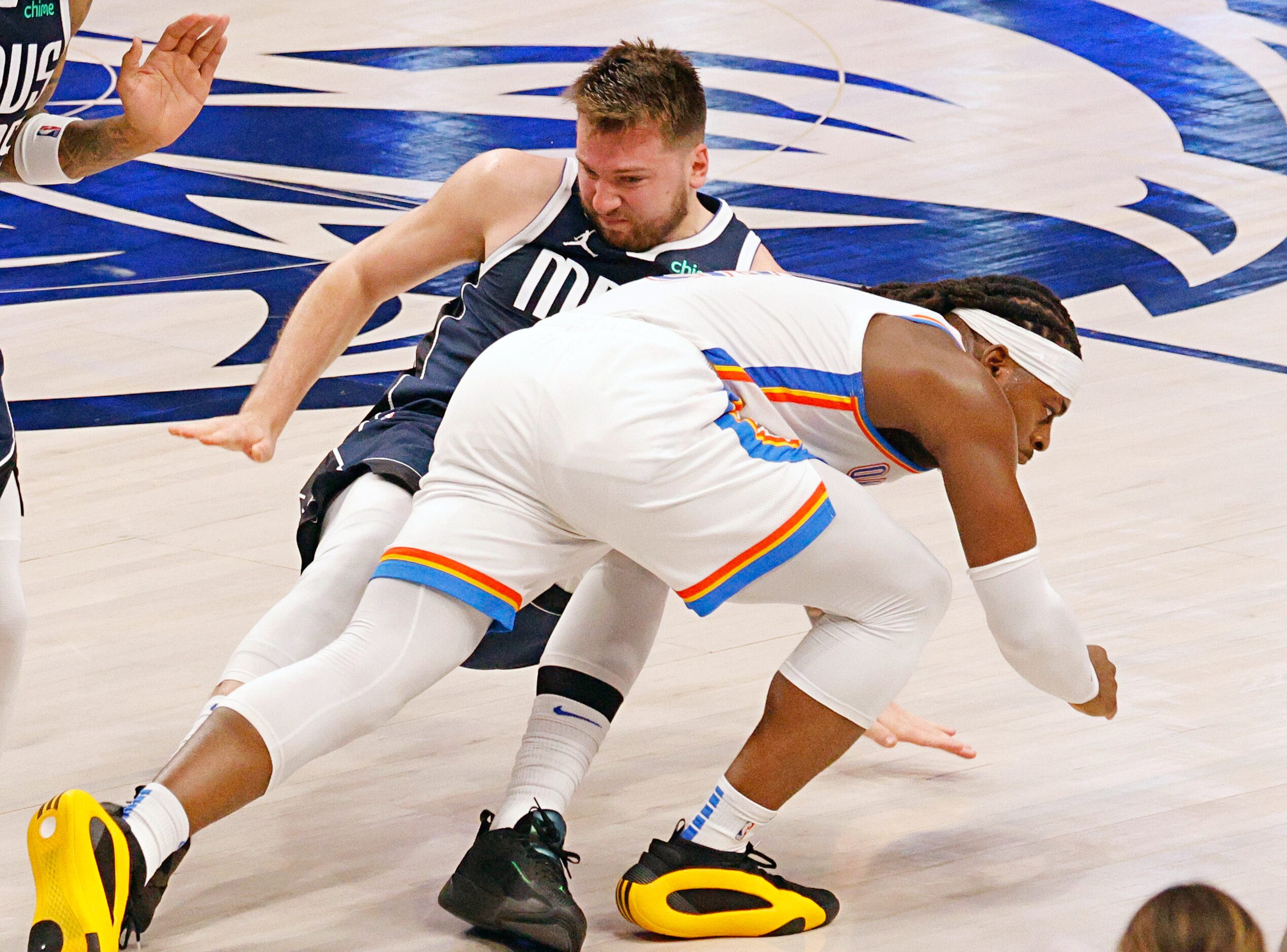 Oklahoma City Thunder guard Luguentz Dort (5) crashes into Dallas Mavericks guard Luka...