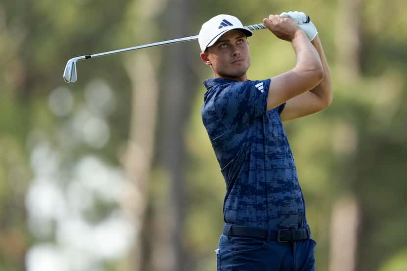 Ludvig Aberg, of Sweden, watches his tee shot on the 15th hole during the first round of the...