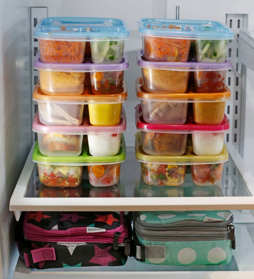 A  refrigerator filled with bento boxes 