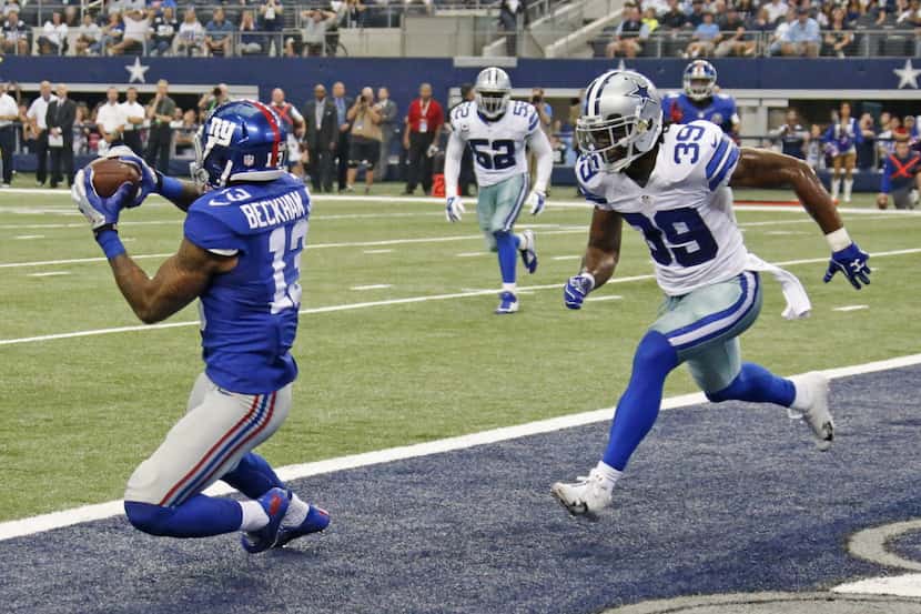 New York receiver Odell Beckham Jr. (13) catches a touchdown pass in front of Dallas Cowboys...