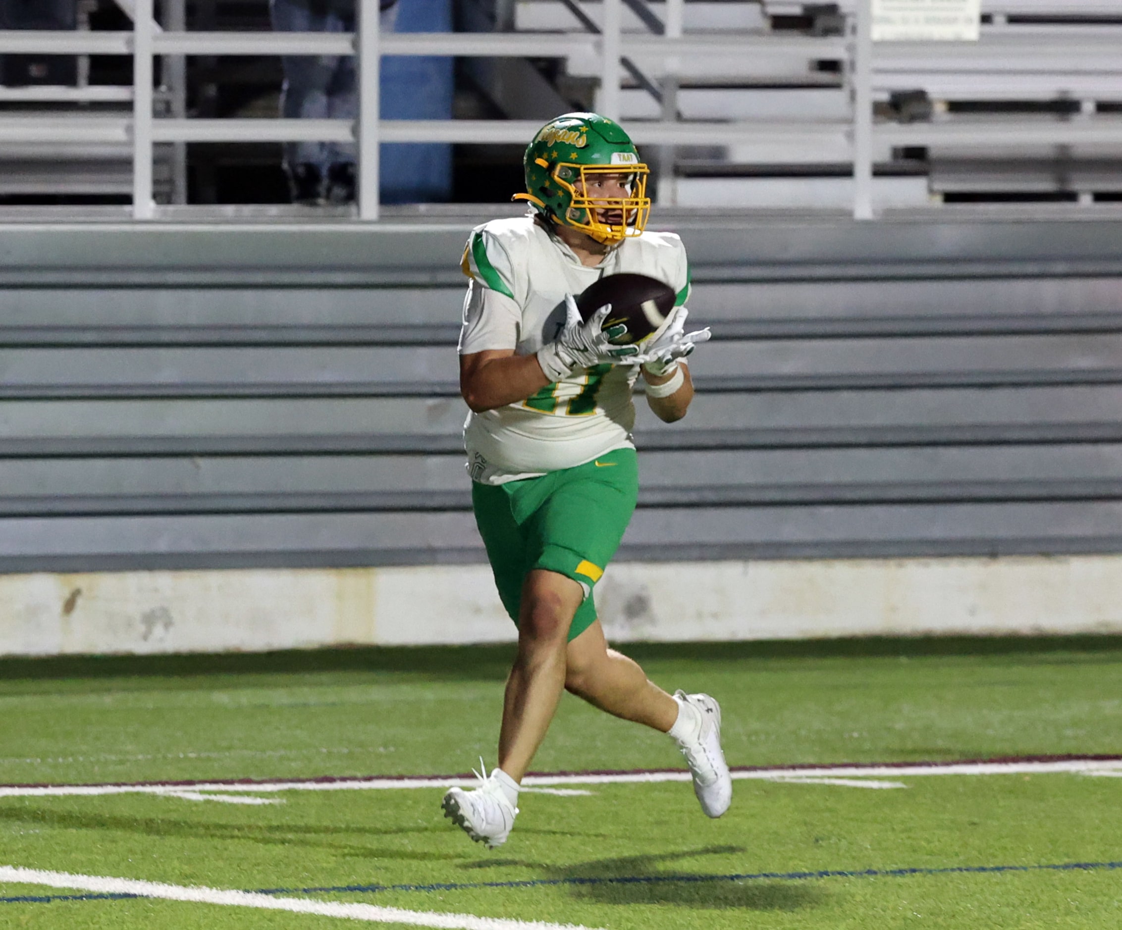 Carrollton Newman Smith High Alex Segura (11) catches a touchdown pass during the first half...