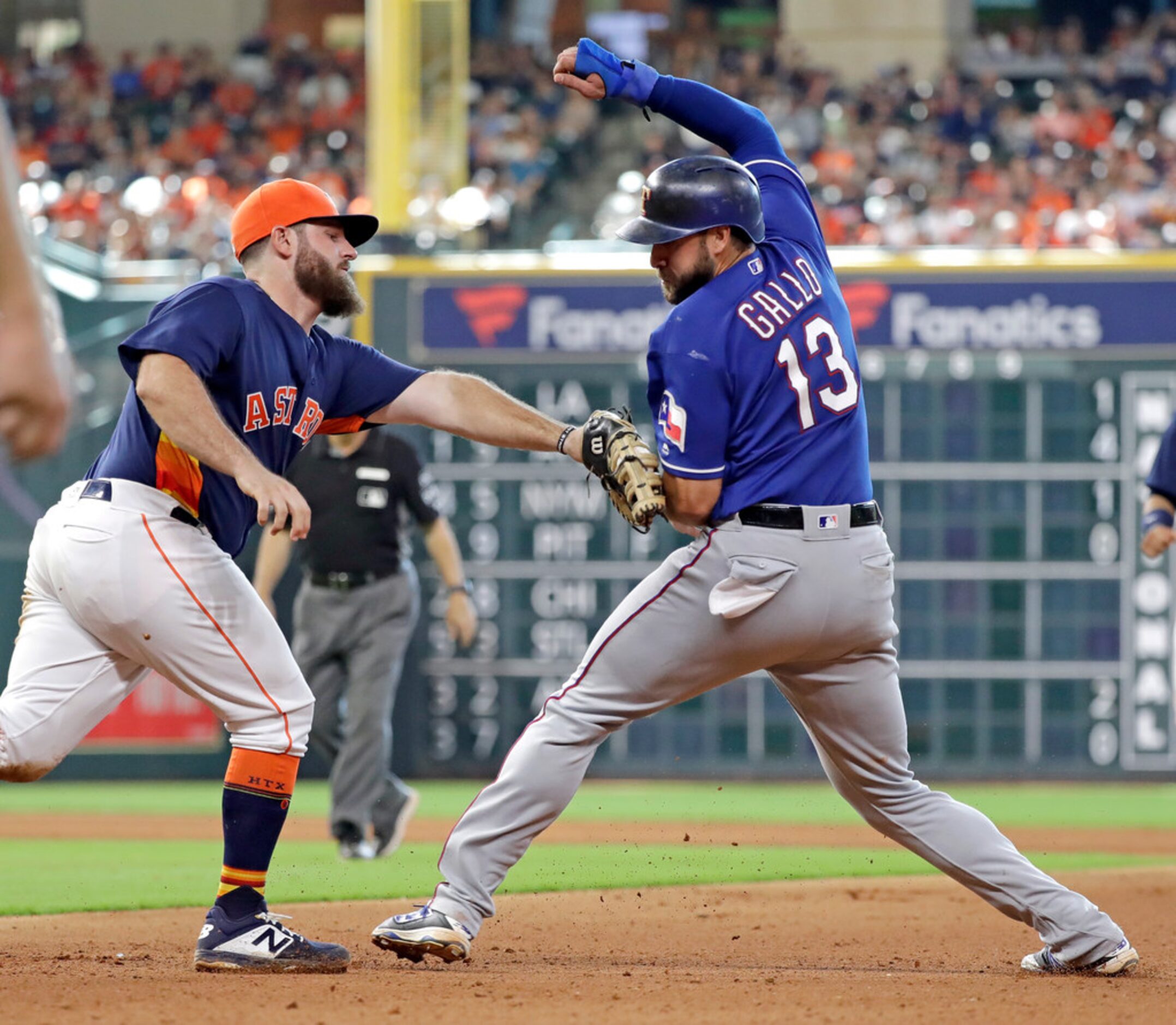 Texas Rangers' Joey Gallo (13) is tagged out by Houston Astros first baseman Tyler White...