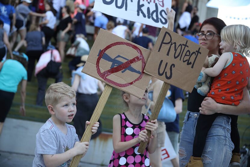 Reef Buehler,4, joins his parents and others after a school shooting that killed 17 to...