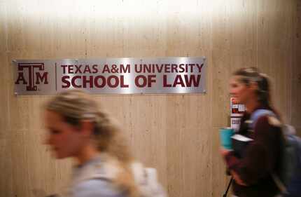 Students pass by a sign on Tuesday, March 29, 2022 at Texas A&M University School of Law in...