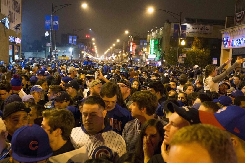 Chicago fans gather in the street to watch the Cubs take on the Cleveland Indians. (Tasos...