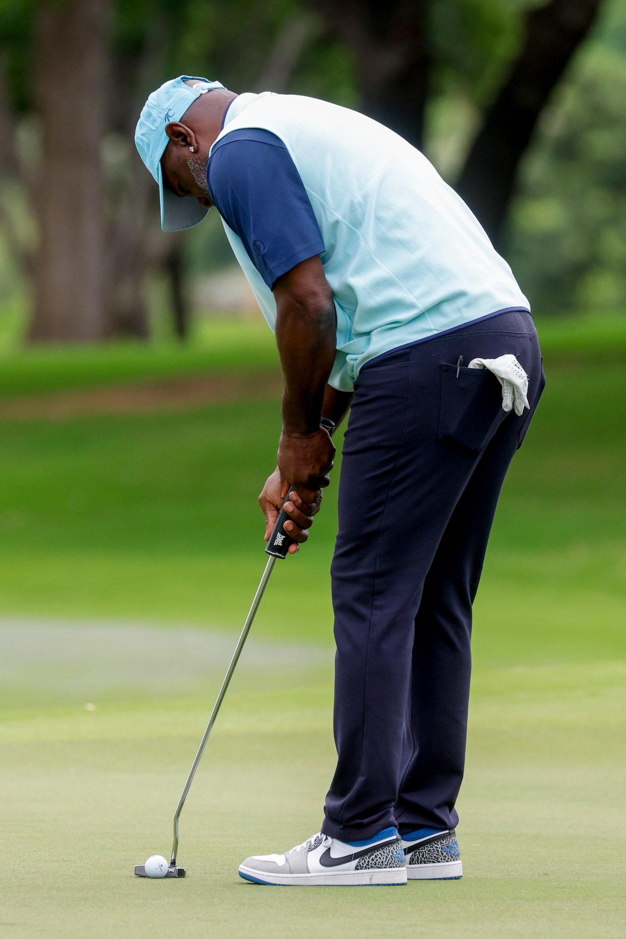 Former Dallas Cowboys running back Emmitt Smith putts on the 9th green during the first...