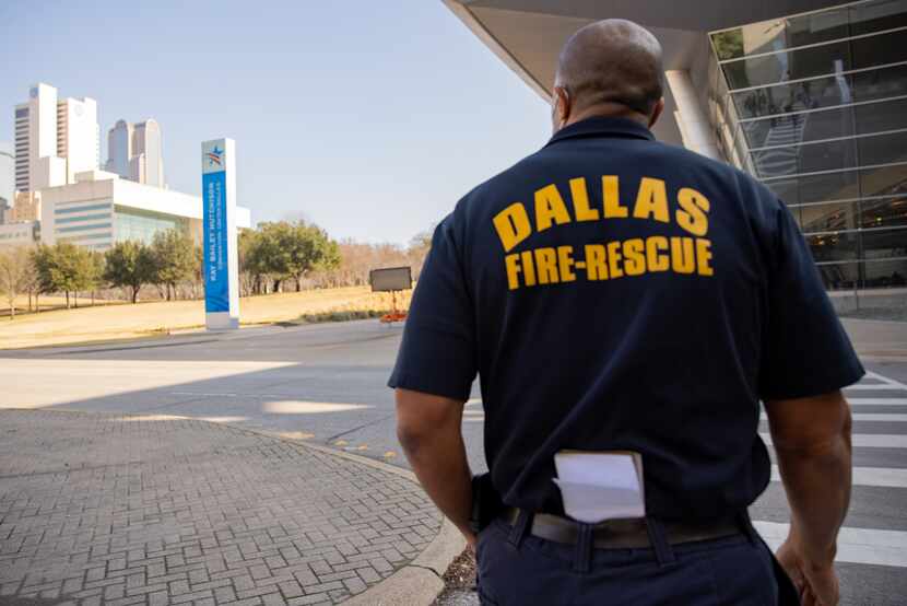Dallas Fire-Rescue works to prepare the drive-up vaccine clinic at Kay Bailey Hutchison...