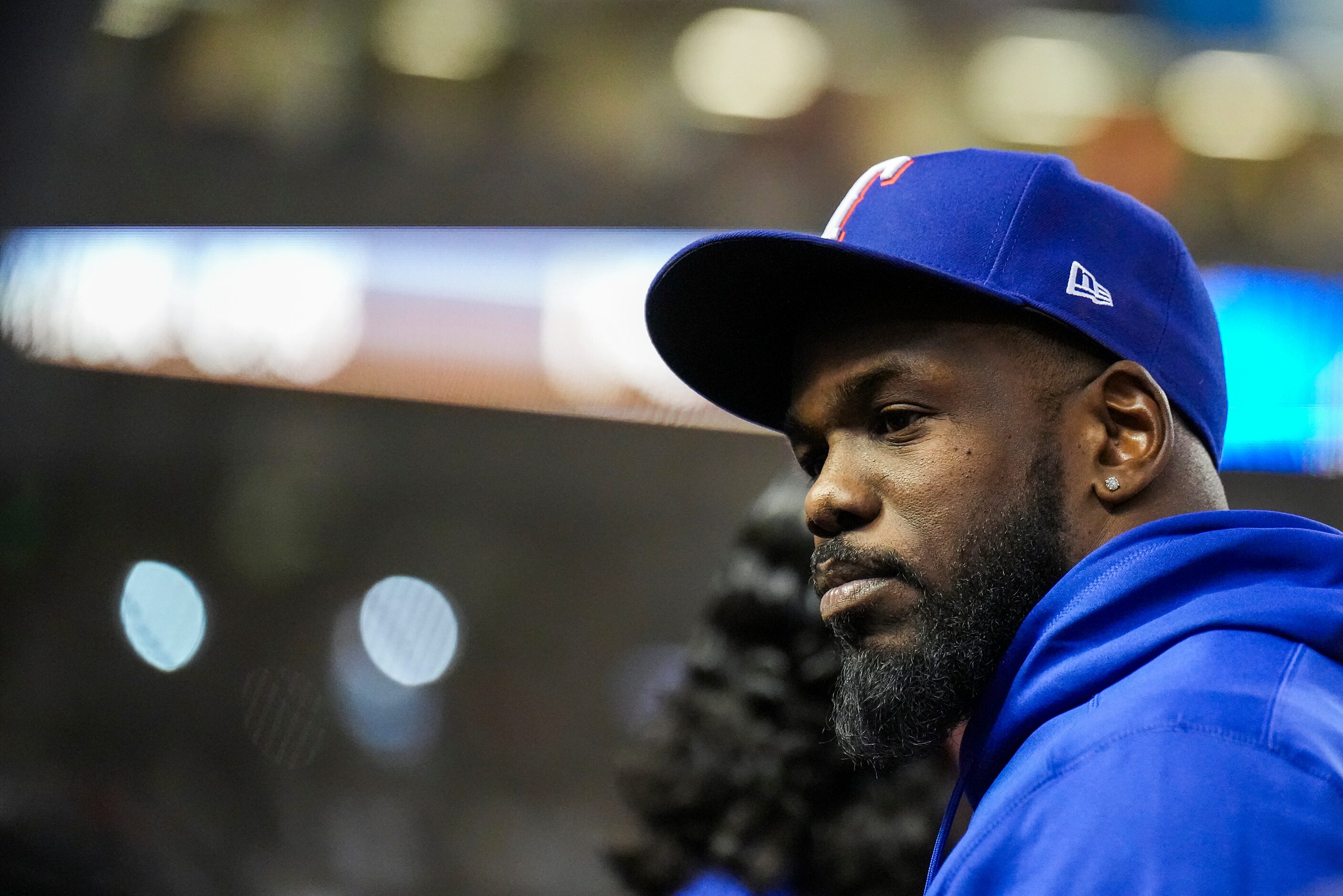 Texas Rangers right fielder Adolis Garcia looks out from the dugout during the sixth inning...