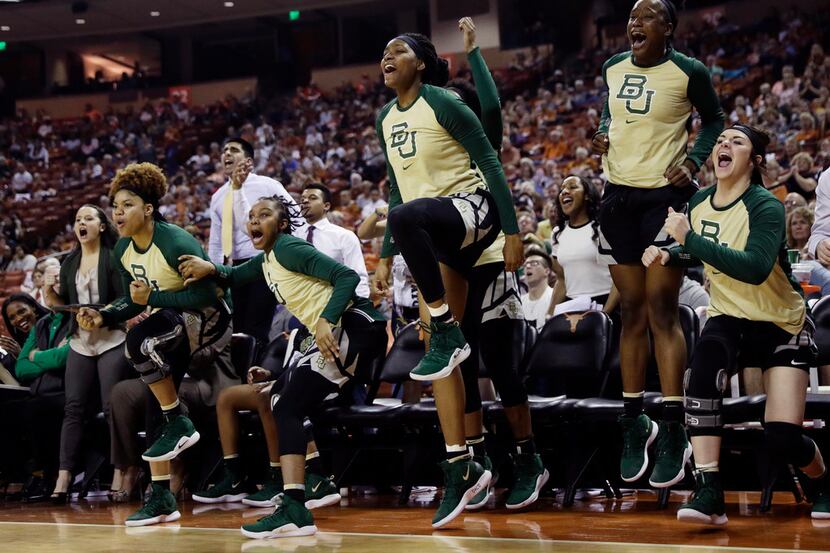 Baylor players celebrate from the bench during the second half of an NCAA college basketball...