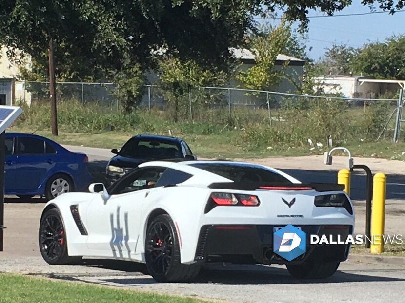 Ezekiel Elliott leaves the Fort Worth Salvation Army in a white Corvette on Monday