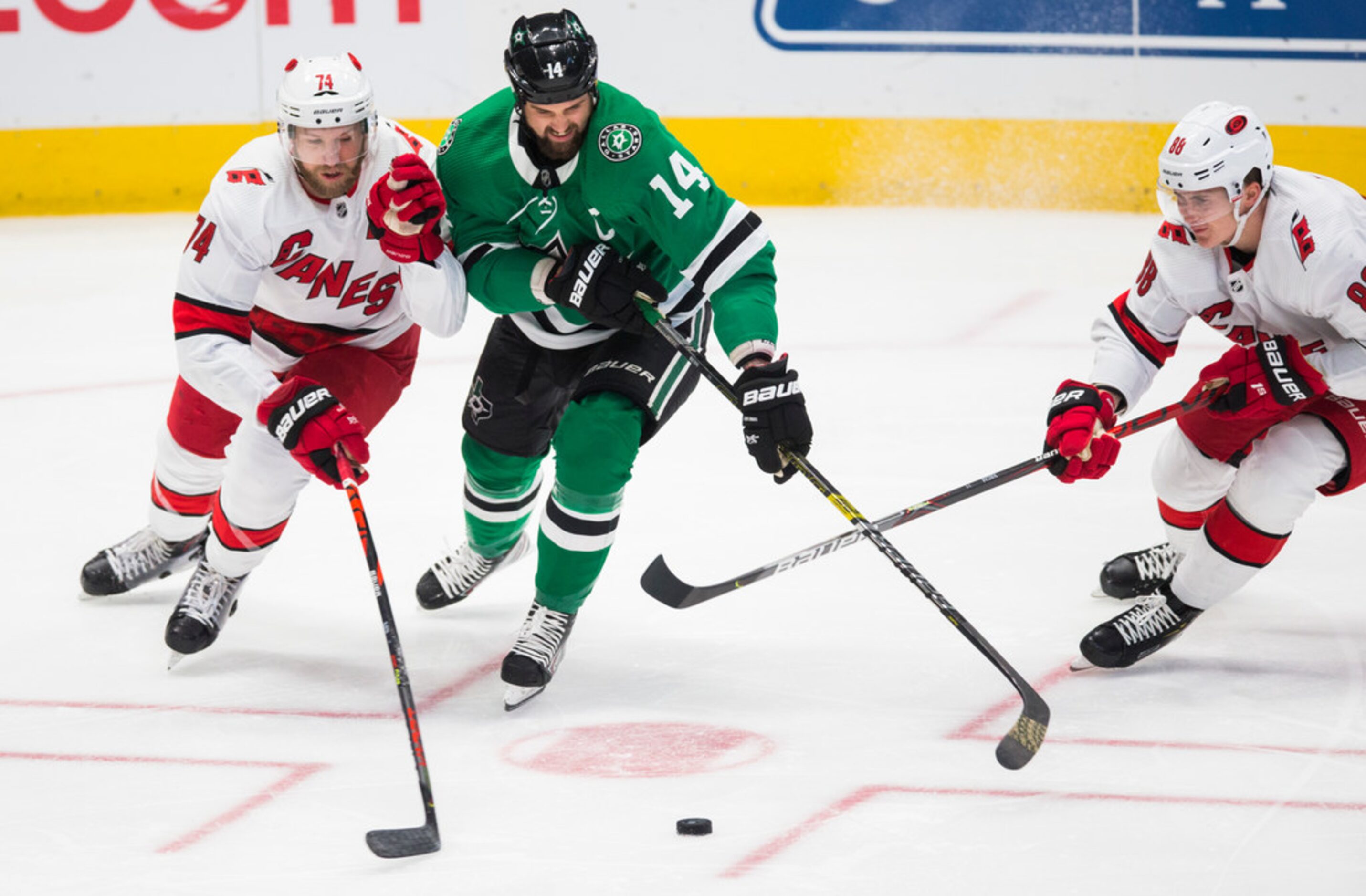 Dallas Stars left wing Jamie Benn (14) fights for the puck with Carolina Hurricanes...