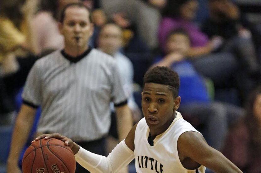 Little Elm’s Devin Pullum drives to the basket in the first quarter as Little Elm High...