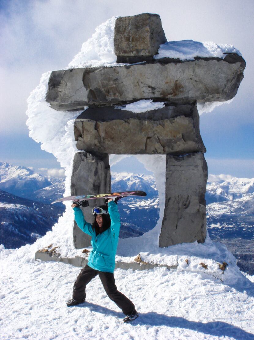 A snowboarder poses in front of the Inuksuk at British Columbia's Whistler Blackcomb Resort....