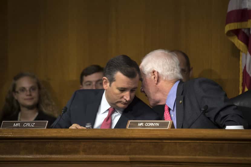 Sens. Ted Cruz (R-Texas) and John Cornyn (R-Texas) talk during a hearing of a subcommittee...