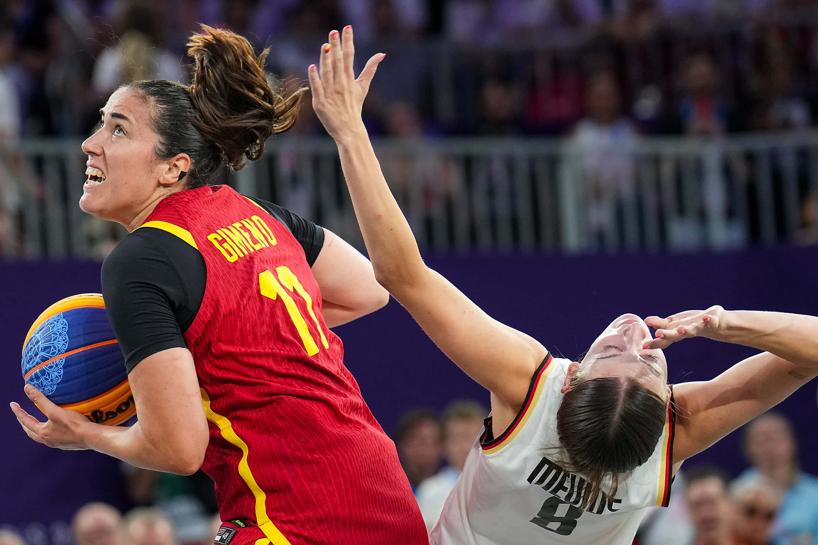 Spain’s Vega Gimeno (11) fouls Germany’s Elisa Mevius (8) reacts to a call during the...