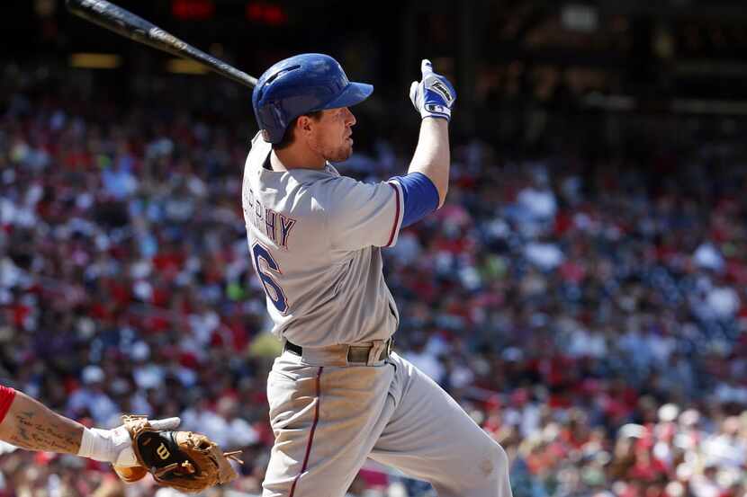Texas Rangers' Donnie Murphy hits an RBI single during the eighth inning of a baseball game...