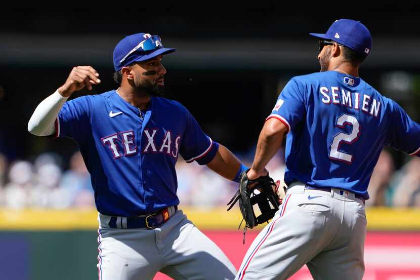 Texas Rangers shortstop Ezequiel Duran celebrates with teammate Marcus Semien (2) after a...