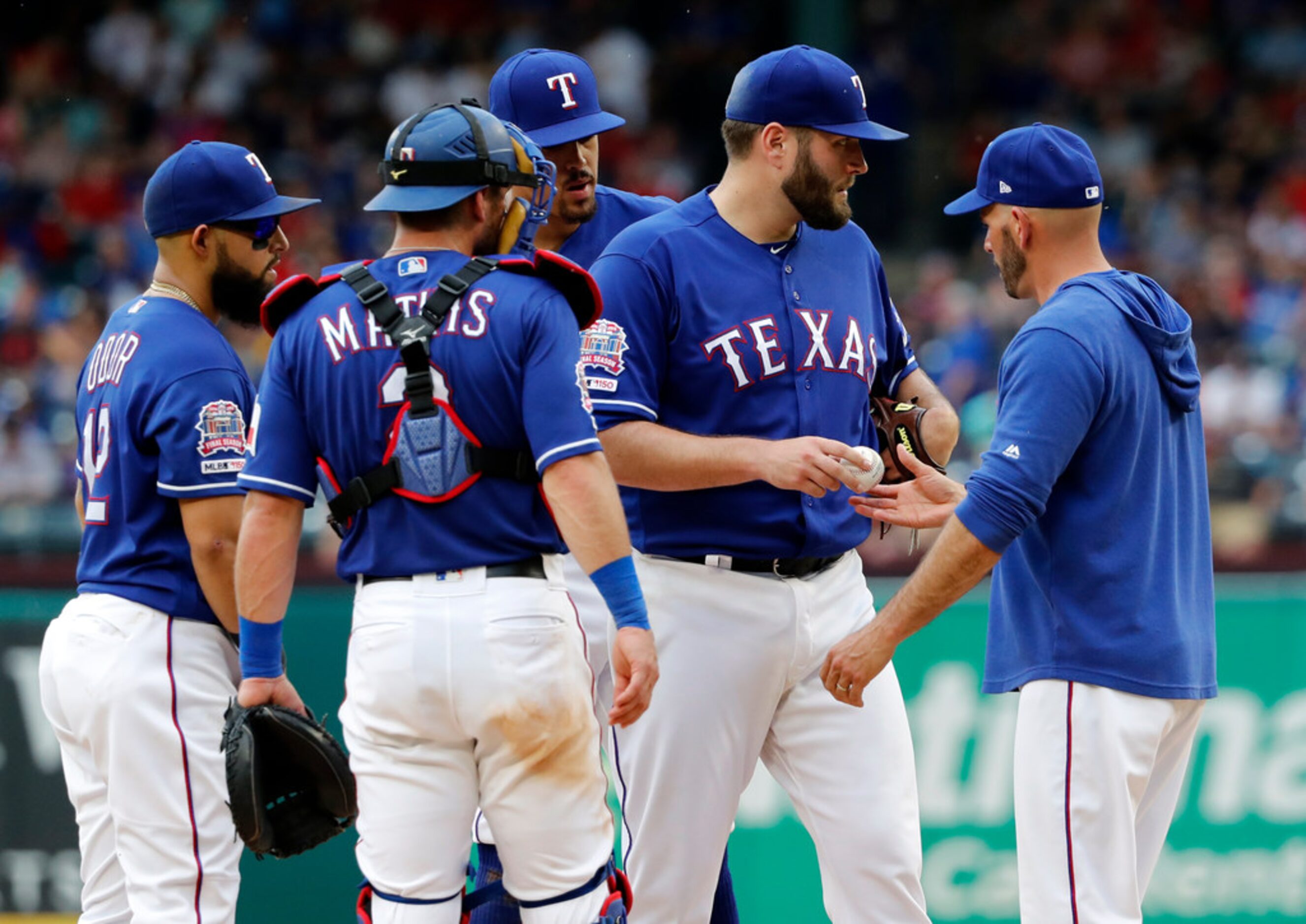 From left to right, Texas Rangers' Rougned Odor,  Jeff Mathis and Ronald Guzman stand by as...