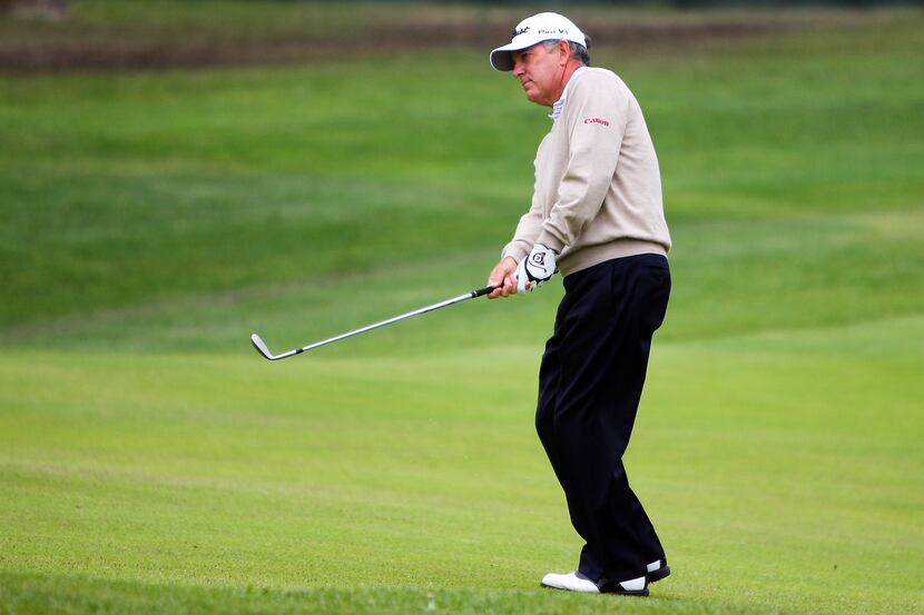 May 23, 2013; St. Louis, MO, USA; Jay Haas chips onto the 18th green during first round of...