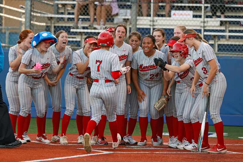 Flower Mound Marcus' Alexa Hanish (7) is greeted by teammates after hitting a solo home run...