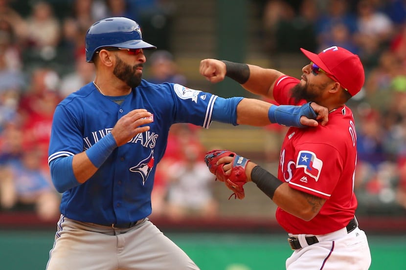 Toronto Blue Jays Jose Bautista (19) gets hit by Texas Rangers second baseman Rougned Odor...