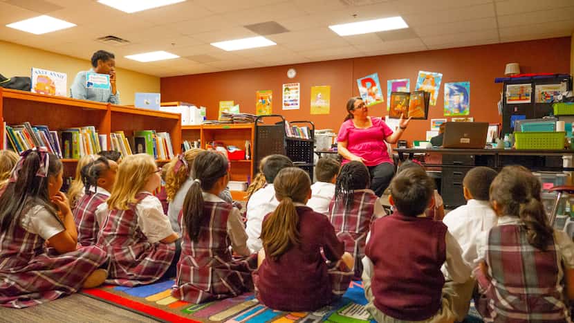 Teacher reading to a group of students in a classroom