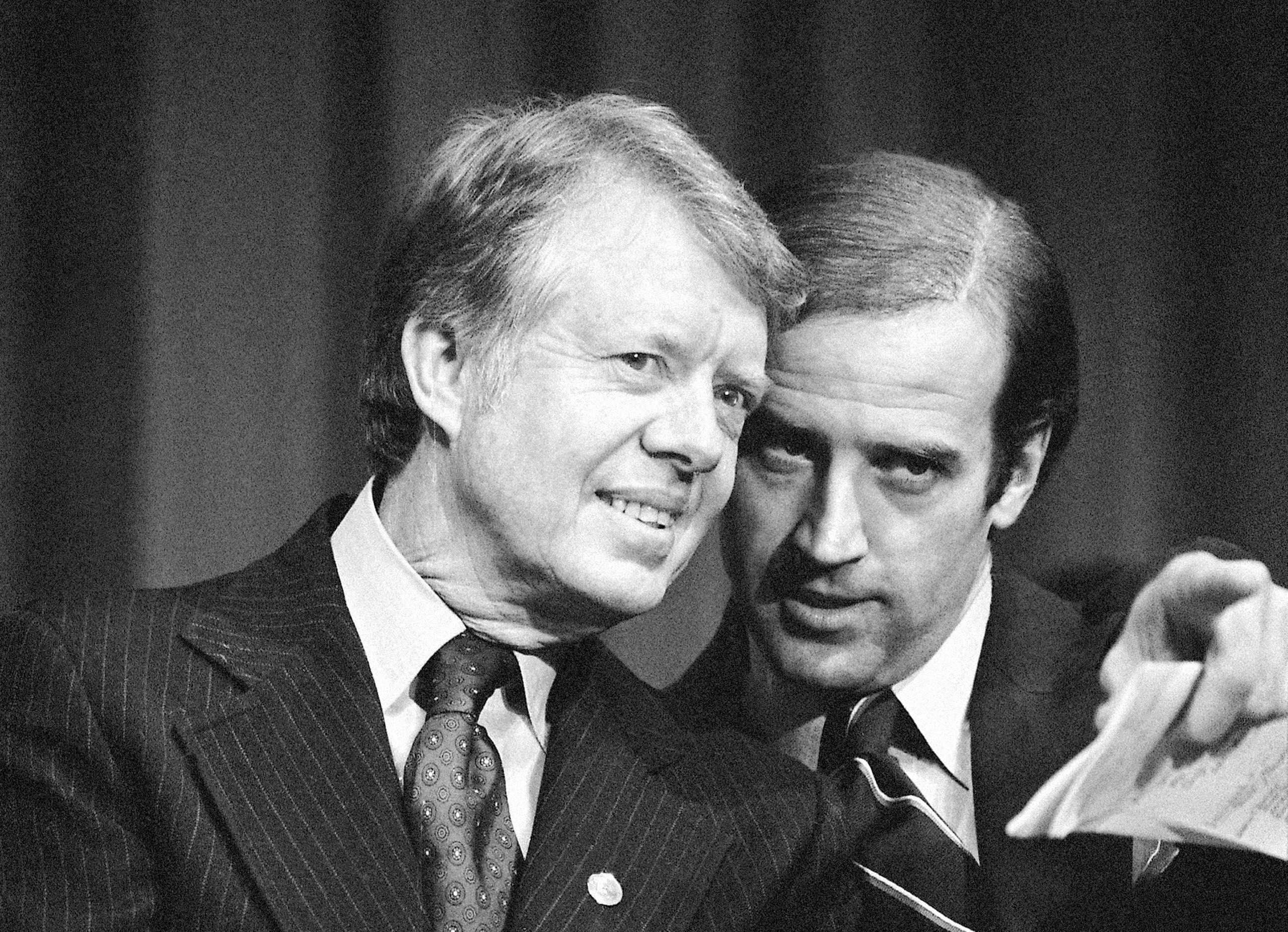 President Jimmy Carter listens to Sen. Joseph R. Biden, D-Del., as they wait to speak at...