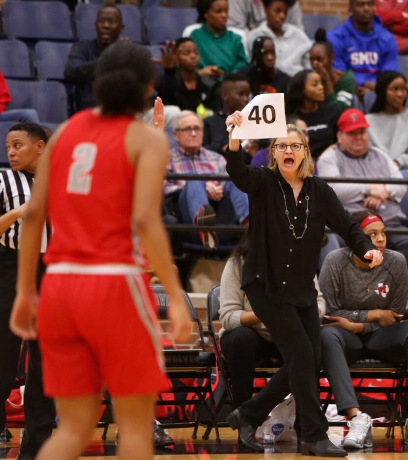 Irving MacArthur head coach Suzie Oelschlegel signals in a play during second half action...