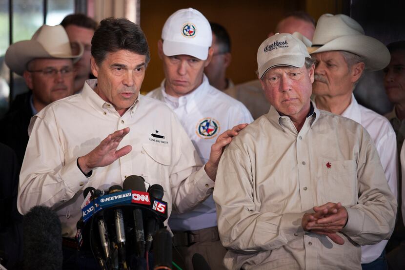 Texas Gov. Rick Perry, left and West, Texas Mayor Tommy Muska, right, during a news...