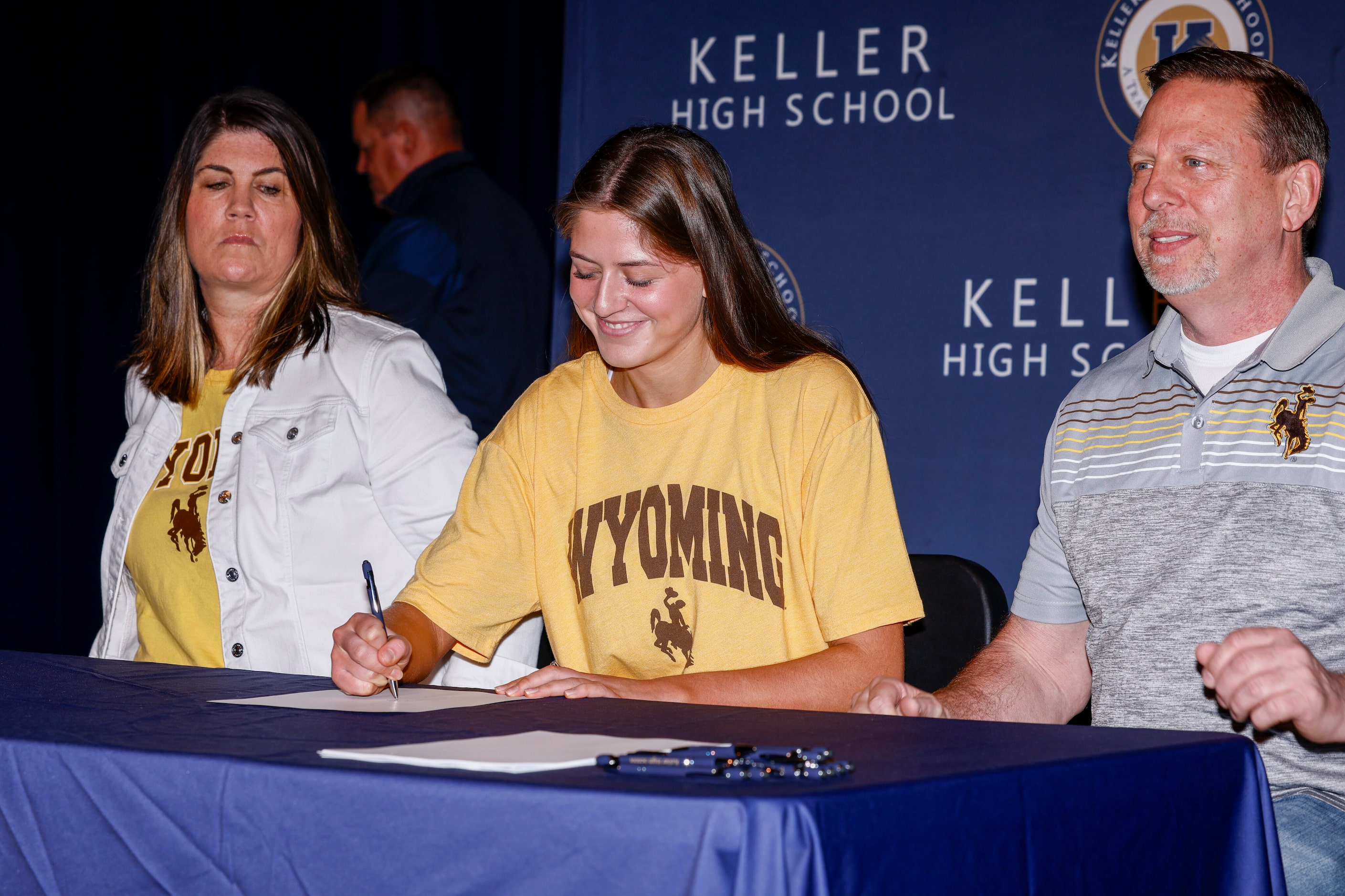 Keller volleyball player Reagan Sharp signs with the University of Wyoming alongside her...