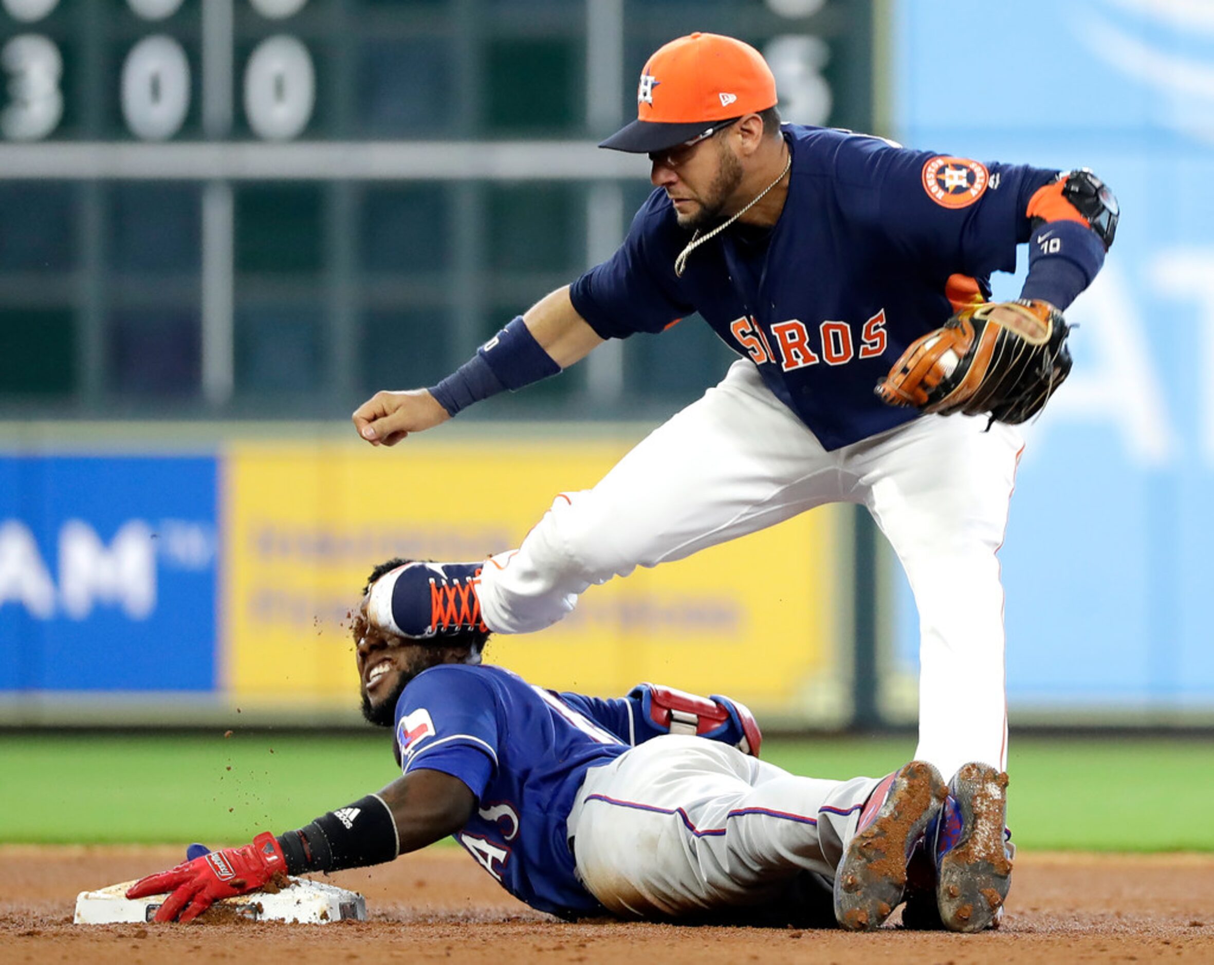 Houston Astros second baseman Yuli Gurriel, right, steps on the face of Texas Rangers'...