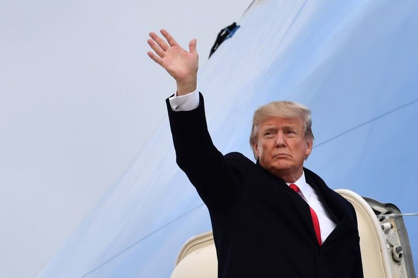 President Donald Trump waves before boarding the Air Force One in Zurich on Friday. 