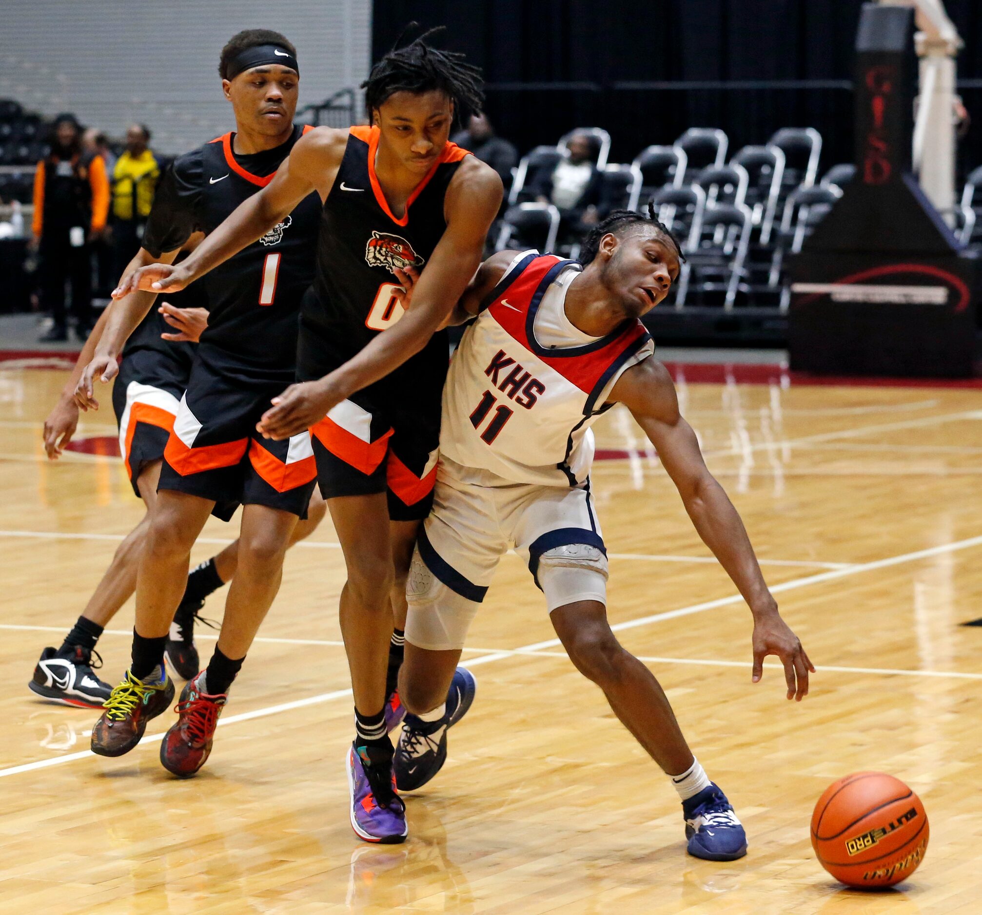 Lancaster High's Dillon Battie (4) fouls Kimball High’s Barack Holland (11) during the Class...