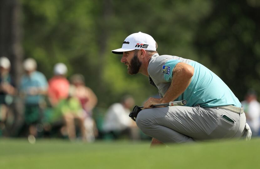 AUGUSTA, GEORGIA - APRIL 12: Dustin Johnson of the United States lines up a putt on the 18th...
