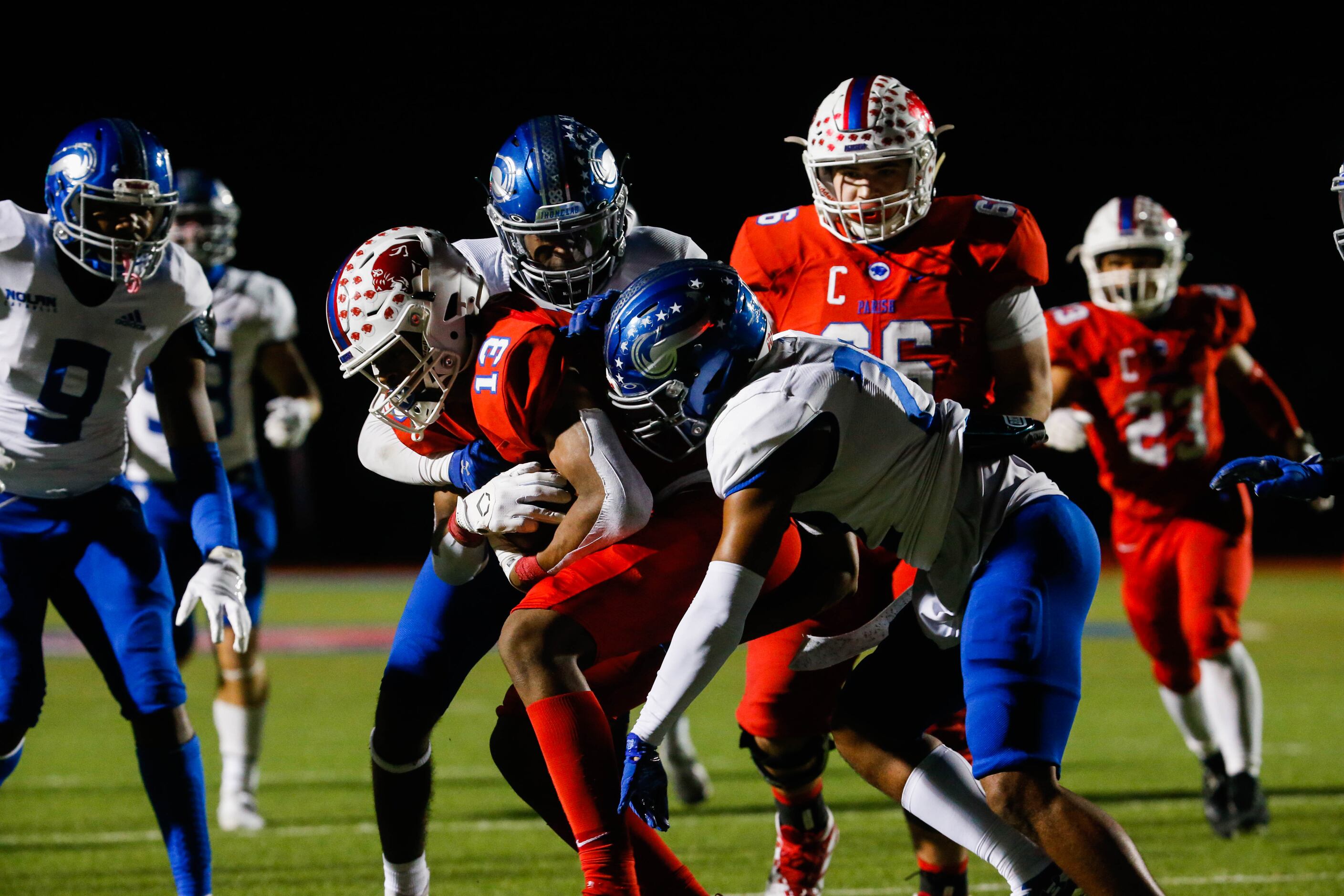 Parish Episcopal's Nathaniel Hill (13) is tackled during the first half of a TAPPS Division...