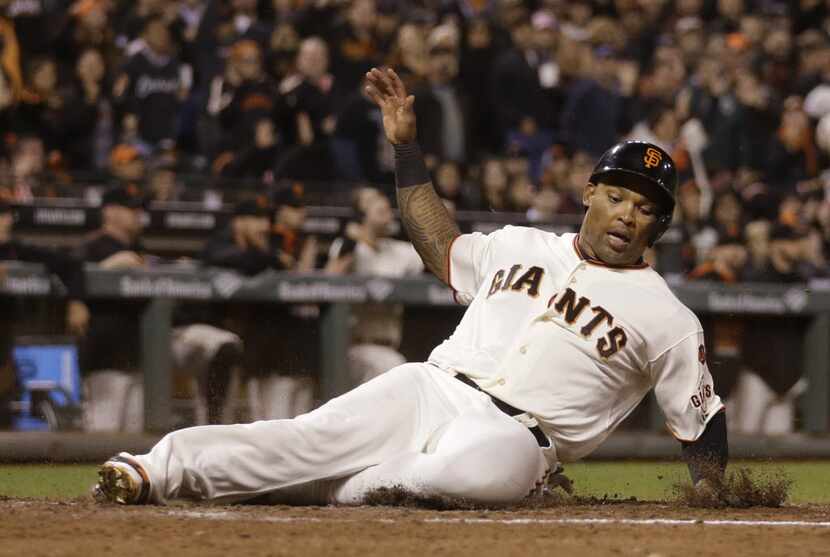 FILE - In this Tuesday, Sept. 15, 2015 file photo, San Francisco Giants' Marlon Byrd slides...